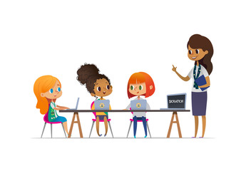 Happy girl scouts sitting at laptops and learning programming during lesson, smiling female troop leader standing near them. Concept of coding for children in scouting camp. Vector illustration.