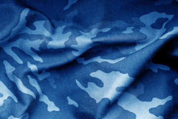 Military uniform pattern with blur effect in navy blue tone. © pavelalexeev
