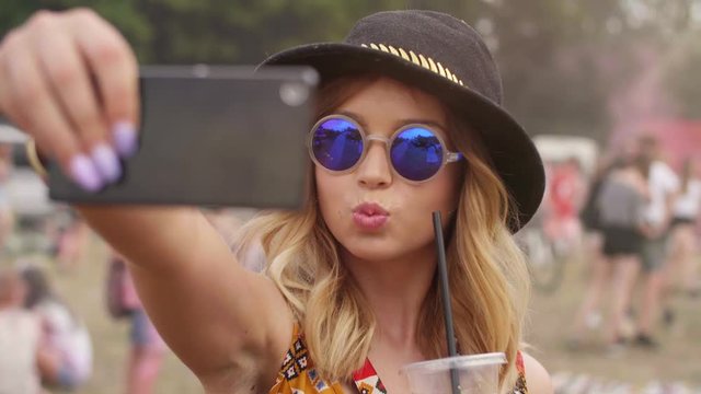 Hipster women making a selfie at the music festival