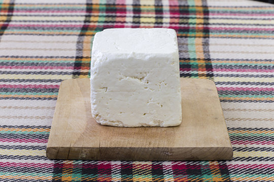 Cutting traditional bulgarian white cheese