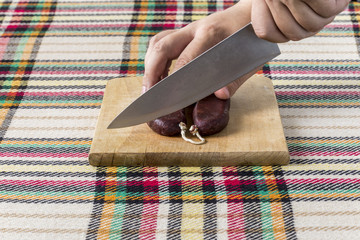 Cutting air-dried sausage called sudzhuk