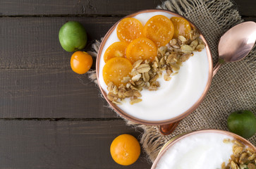 Natural homemade yogurt with ground-cherry on a wooden table.