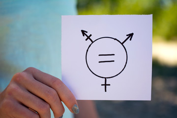 gender definition concept, a piece of paper with a transgender symbol in hand