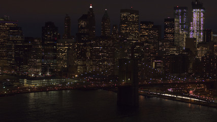 AERIAL: Dense traffic on Brooklyn Bridge freeway leading to downtown Manhattan