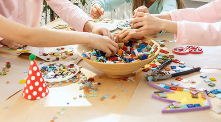 mosaic puzzle art for kids, children's creative game. two sisters are playing mosaic