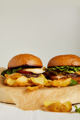 Hot hamburgers and french fries served on craft paper