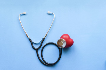 Day of cardiologist, Cardiology, Black stethoscope with red heart on blue background, heart disease, diagnosis of heart disease
