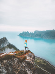 Summer vacations travel journey woman traveler on mountain cliff over sea alone hike in Norway...