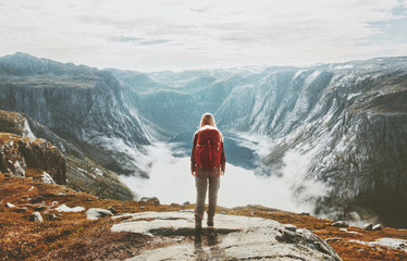 Traveler exploring mountains alone hiking with backpack adventure journey summer vacations traveling lifestyle weekend getaway in Norway - obrazy, fototapety, plakaty