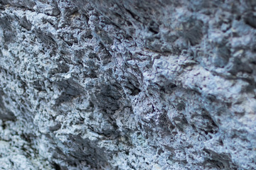 texture of a stone friable wall close-up, selective focus