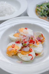 Salted eggs salad in white plate and selective focus.