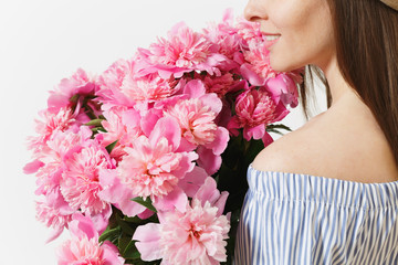 Close up cropped photo of tender woman holding, sniffing bouquet of pink peonies flowers isolated on white background. St. Valentine's Day, International Women's Day holiday concept. Advertising area.