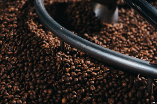 Traditional coffee roaster with coffee beans in cylinder