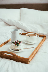Cozy home breakfast in bed in white bedroom interior 