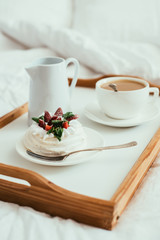 Cozy home breakfast in bed in white bedroom interior 