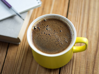 Coffee mug and notebook with book