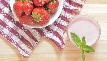Red large strawberries on a white plate