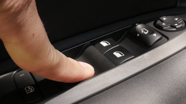 Slow motion car window button pressing video