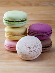 french colorful macarons on a wooden floor