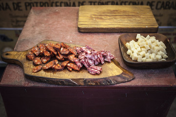 Table display sausages and cheese.