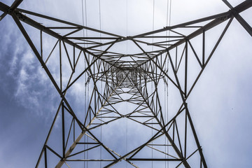 Electricity tower seen from below and blue sky.