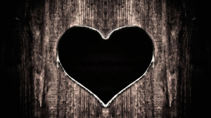 Heart carved in a tree on a dark background