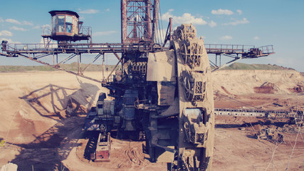 The operating machines in the quarry for the extraction of manganese ore