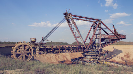Fototapeta premium The operating machines in the quarry for the extraction of manganese ore
