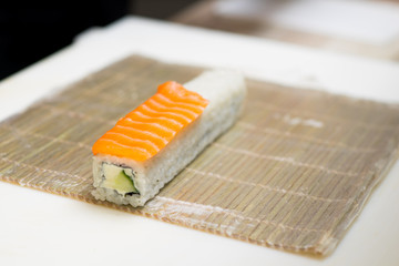 Sushi master, cutting sushi rolls. Making sushi rolls. 