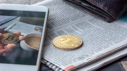 Morning news  cryptocurrency with newspaper and bitcoin on mobile screen.