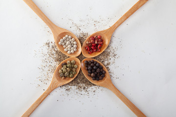 Pepper mill on a white isolated background with peppers