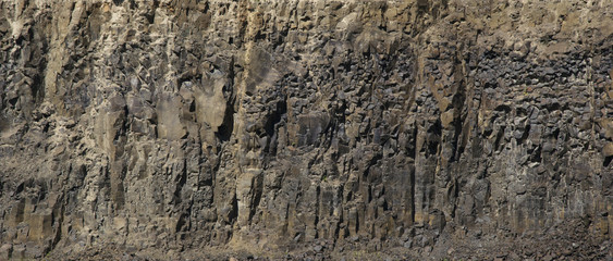 The stone texture of the basalt rock that remained after the extinct volcano. Natural background.