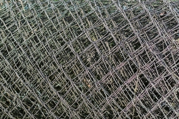 Background of rolled Metal chain-link fence outdoors