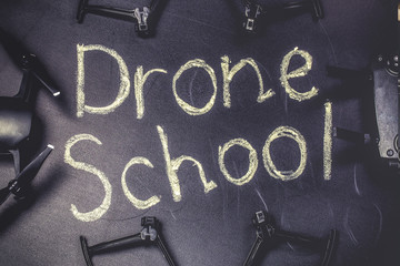chalkboard inscription on the blackboard  drone school, near quadrocopter and its accessories,...