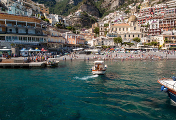 People are resting on a sunny day at the beach in Positano on Amalfi Coast in the region Campania, Italy