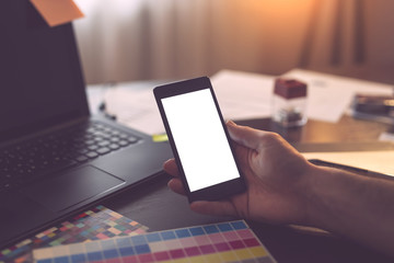 Designer using a smart phone