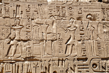 Ancient Egyptian murals and writings on the stone walls of the Karnak Temple in Luxor