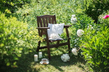 a wooden chair in the garden and cup of tea