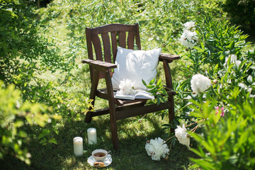 a wooden chair in the garden and cup of tea