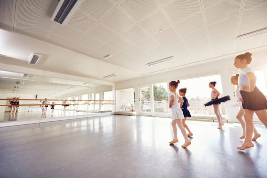 Group of little ballet dancing girls practicing in class