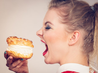 Funny woman holds cream puff cake