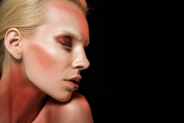 attractive tender woman with red makeup, isolated on black