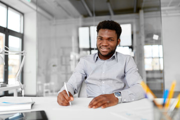 business and people concept - smiling african american businessman at office