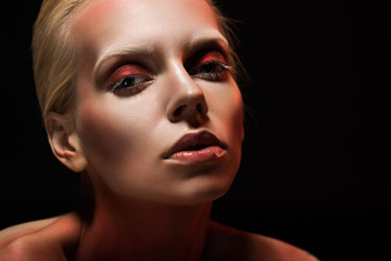 attractive young woman with stylish makeup, isolated on black