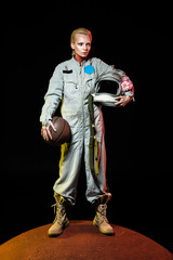 cosmonaut in spacesuit holding basketball ball and helmet with flower while standing on red planet © LIGHTFIELD STUDIOS