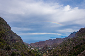 Fototapeta na wymiar Rainbow over the mountains of La Gomera