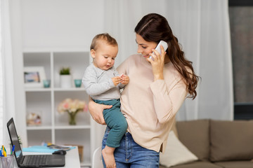 motherhood, multi-tasking, family and technology concept - happy mother with baby calling on...