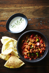 Tortilla with chili pork and sour cream sauce 