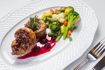 Meat steak with vegetables garnish on white background