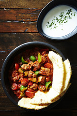 Tortilla with chili pork and sour cream sauce 